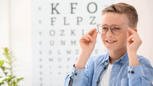 Little boy wearing glasses at ophthalmologist's office